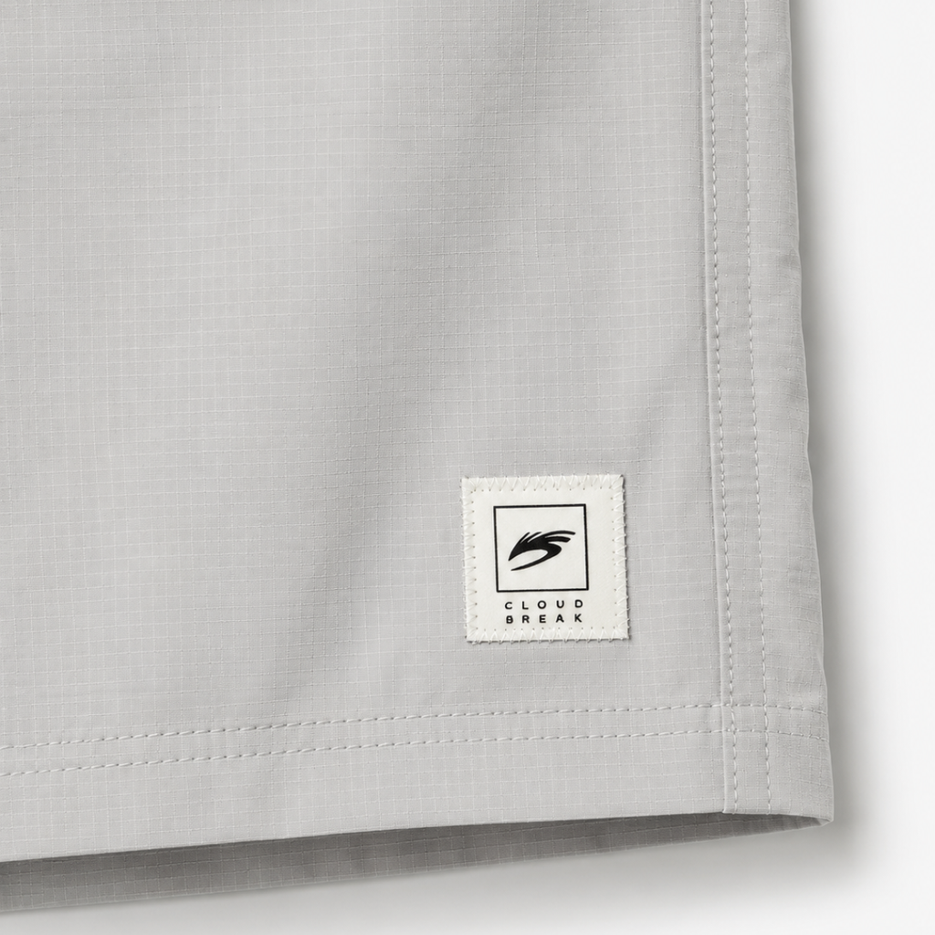 Close-up of a gray fabric with a brand label on a white background