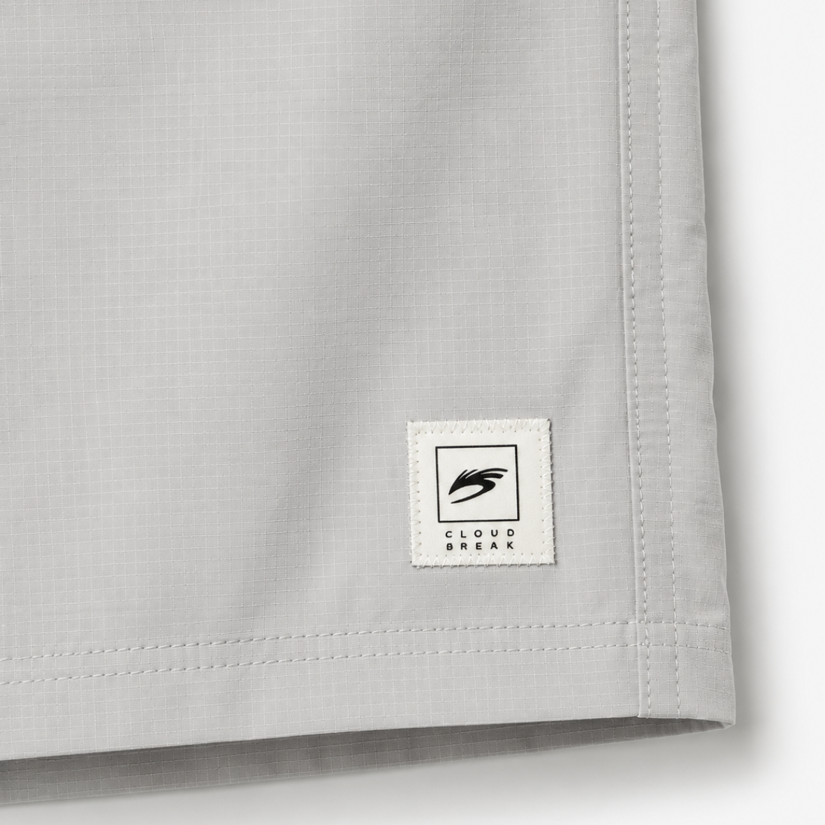 Close-up of a gray fabric with a brand label on a white background