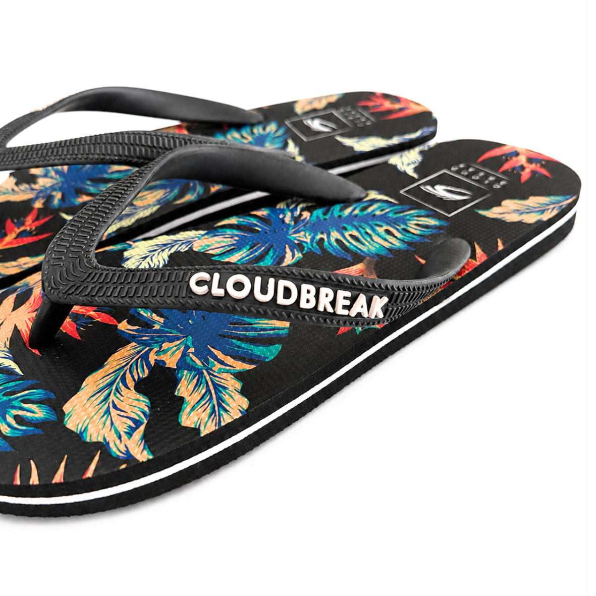 Flip-flops with tropical leaf pattern and 'Cloudbreak' branding on a white background