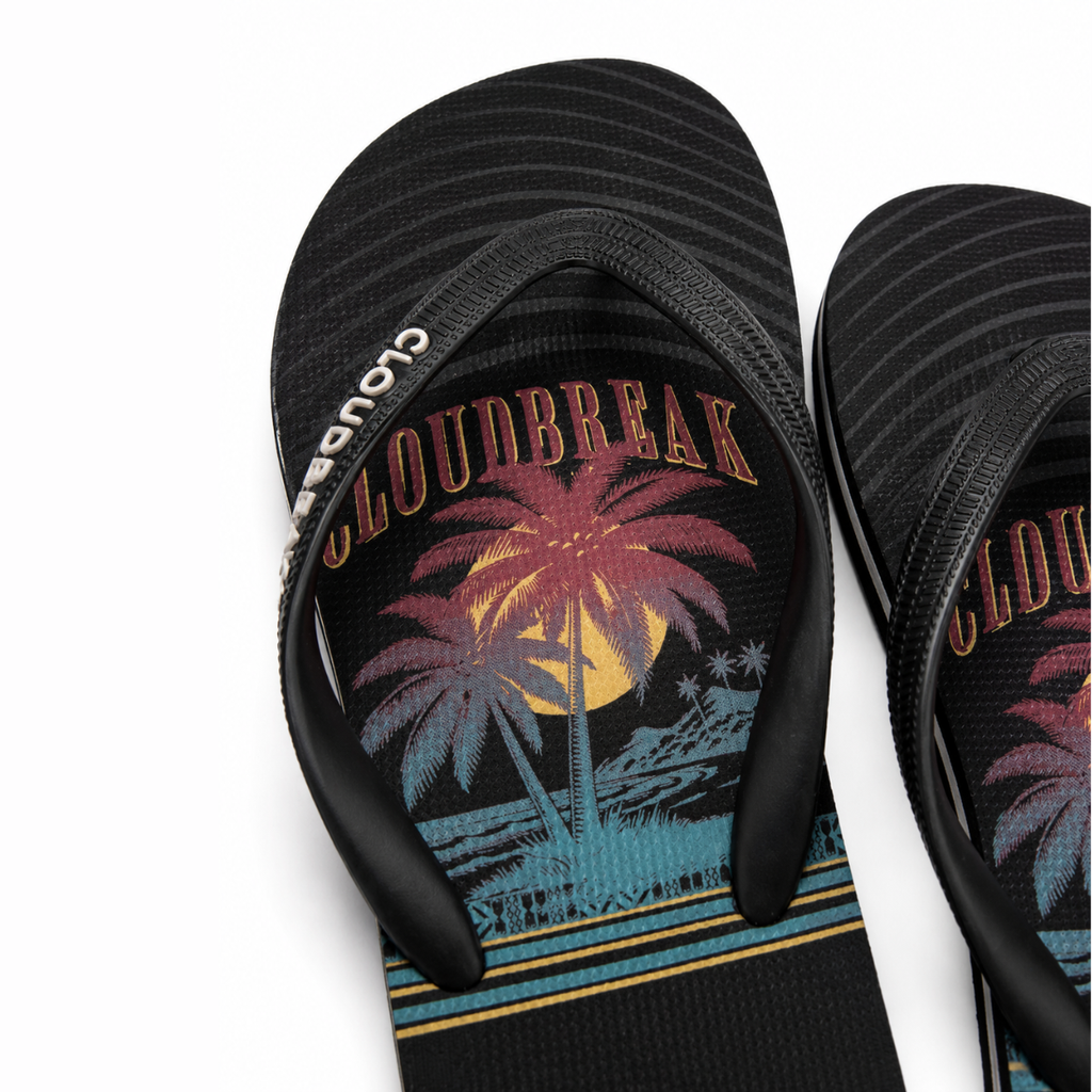 Black flip-flops with a palm tree and moon design on a white background