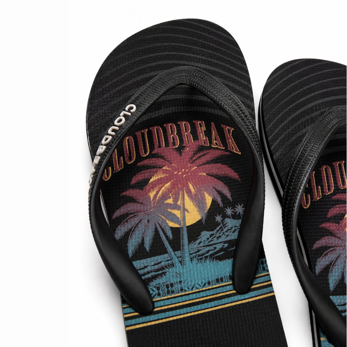 Black flip-flops with a palm tree and moon design on a white background
